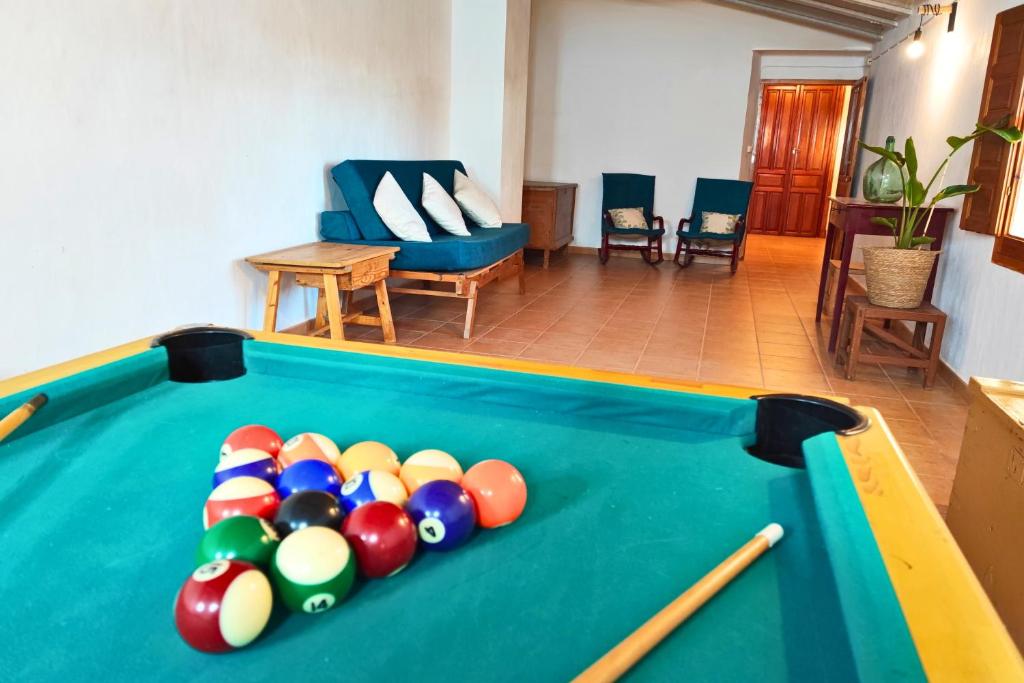 a pool table with balls in a living room at Casa Rural con Patio y Barbacoa en Pinoso 
