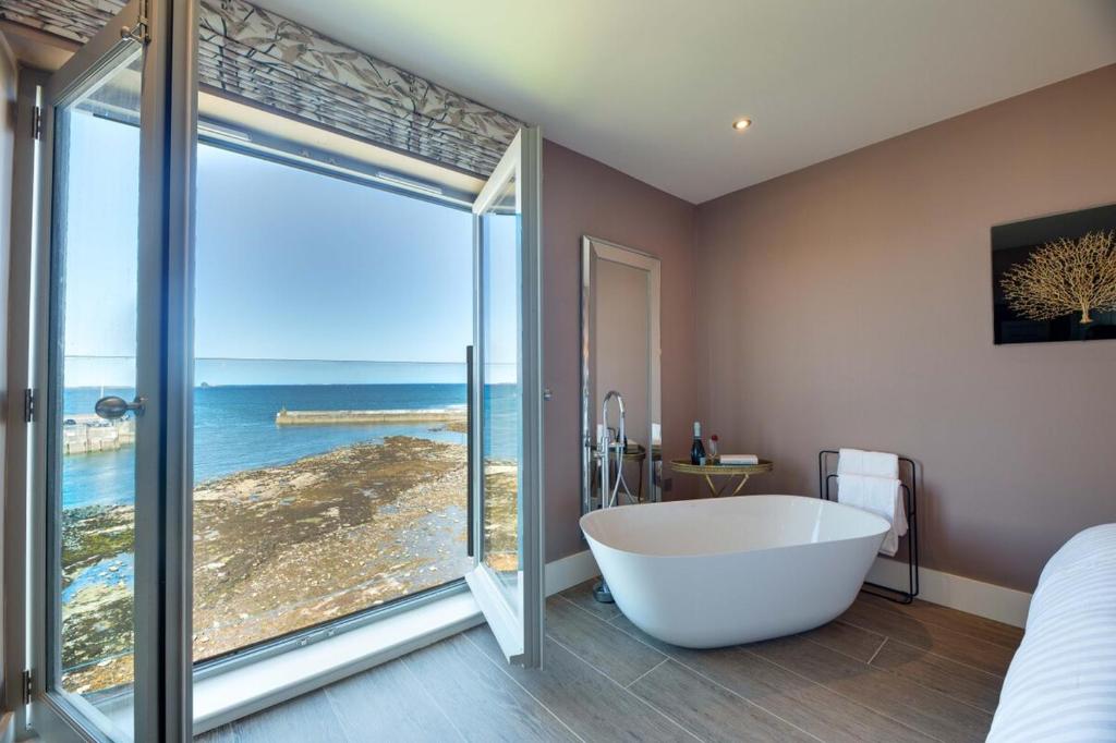 bagno con vasca e vista sull'oceano di Coot's Nest Seahouses a Seahouses