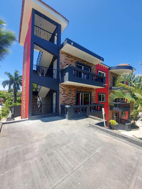 a large building with a staircase in front of it at Eskapaz luxury in Sosua