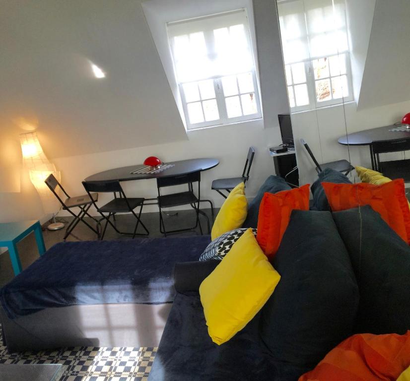 a living room with a couch and a table at La Plage en Normandie in Pourville-sur-Mer