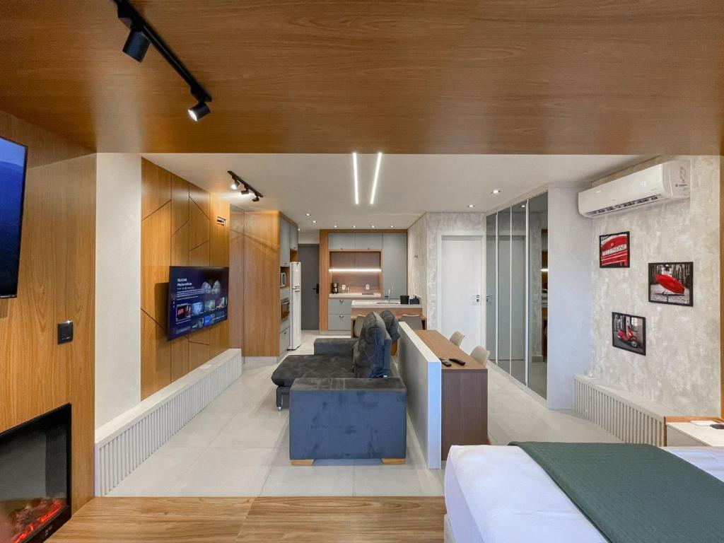 a living room with a couch and a tv in a room at Luxury Collection - The Frame in Campo Grande