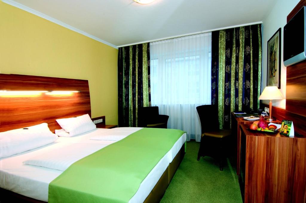 Postel nebo postele na pokoji v ubytování NP Hotel Wallis