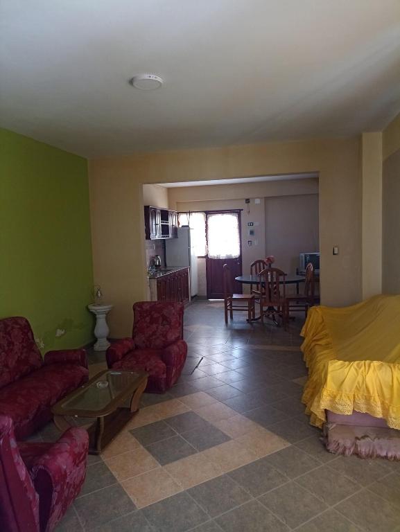 a living room with a couch and chairs and a table at Alojamiento temporal - Alto Comedero in San Salvador de Jujuy