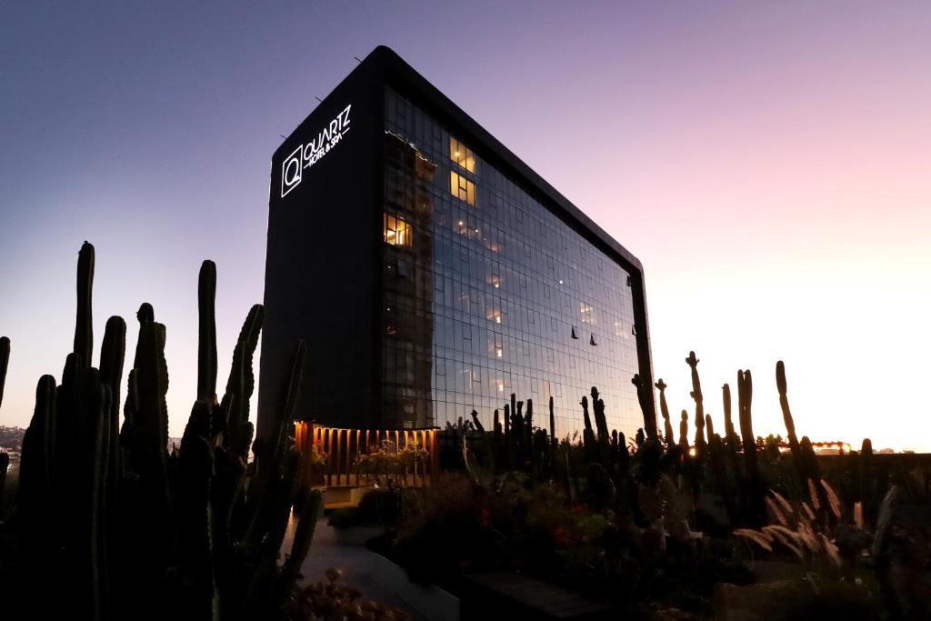 a building with a sign on the side of it at Quartz Care Hotel & Spa Tijuana in Tijuana