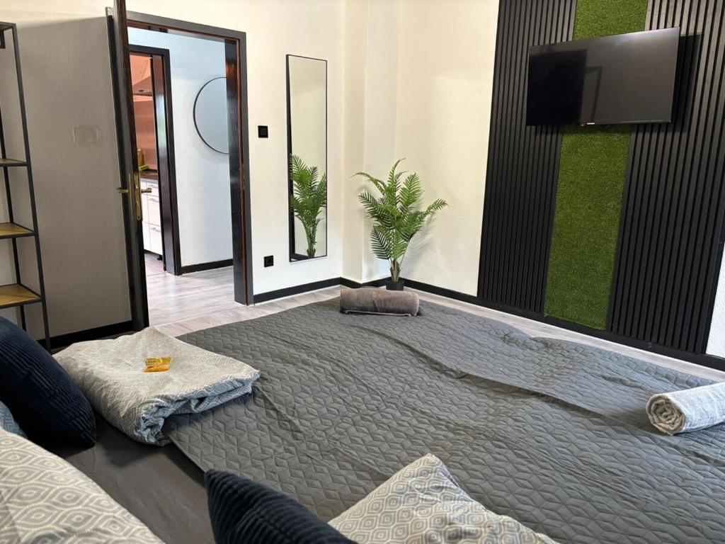 a bedroom with a large bed with a tv on the wall at Schönes Apartment in der Altstadt in Koblenz