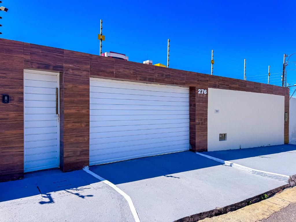 a pair of garage doors on a building at Beach House Atalaia in Aracaju