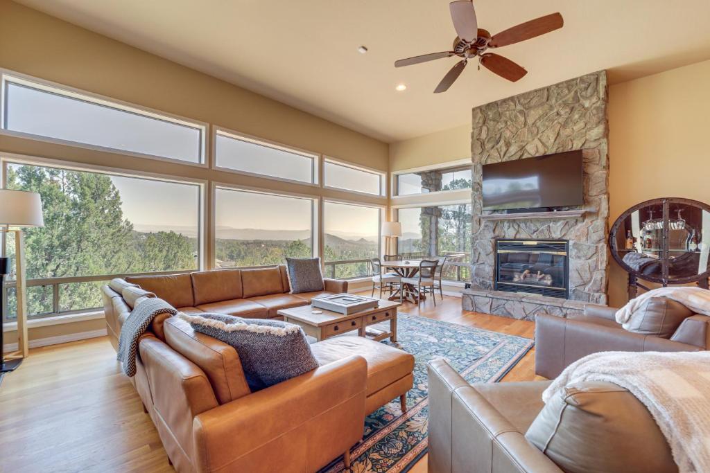 a living room with couches and a fireplace at Panoramic Views Luxe Payson Paradise! in Payson