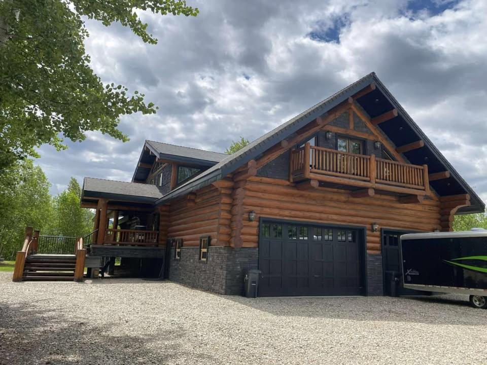 a log home with a garage and a house at Southview Lodge in Valemount