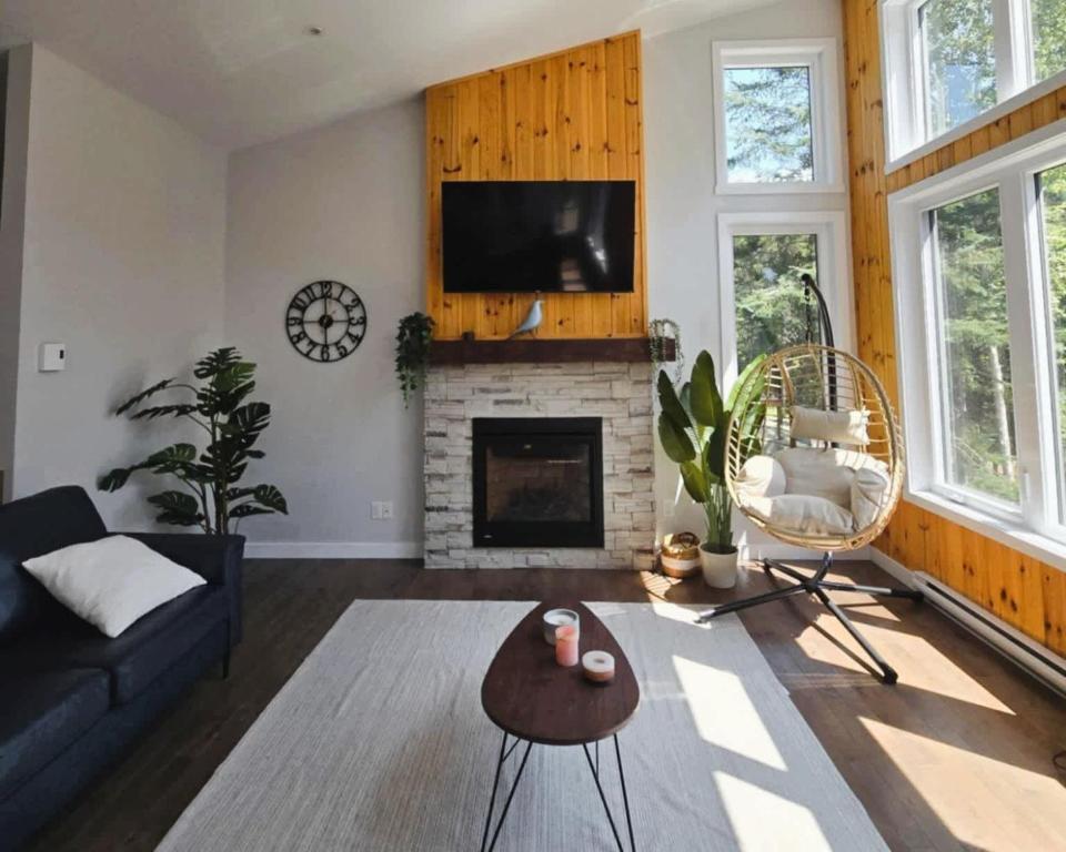 a living room with a couch and a fireplace at Chalet Ankoay - Relaxation Nature & Private Spa in Saint Come