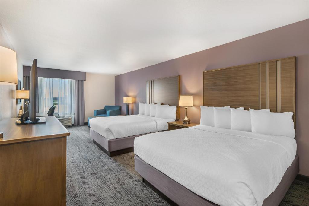 a hotel room with two beds and a television at Best Western Plus Rapid City Rushmore in Rapid City