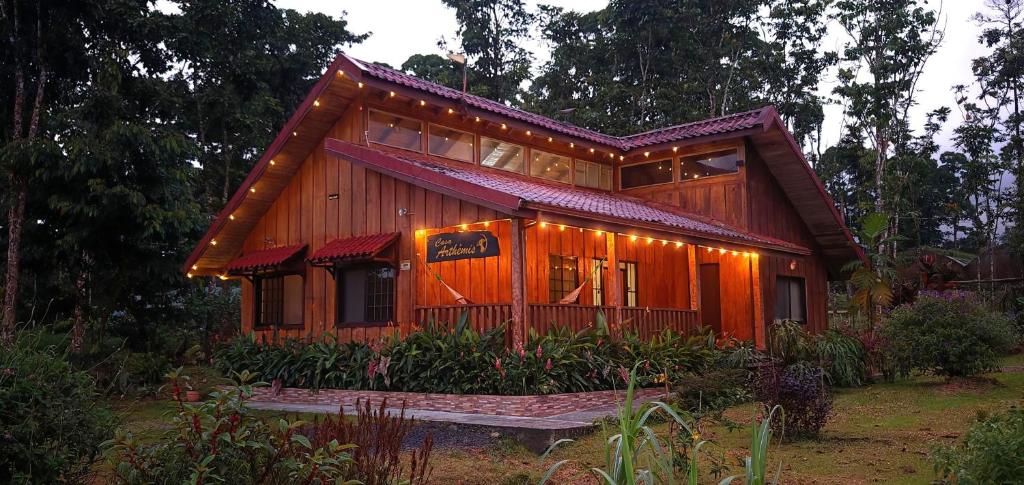a house with lights on the front of it at Casa Arthémis - Rainforest Lodge in Guápiles