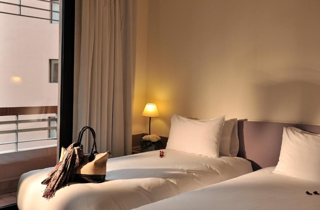 Postel nebo postele na pokoji v ubytování Novotel Marrakech Hivernage