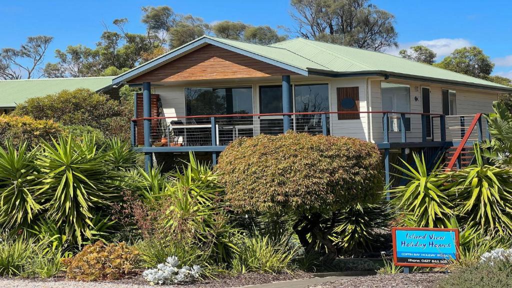 a house with a sign in front of it at Island View 1 in Coffin Bay