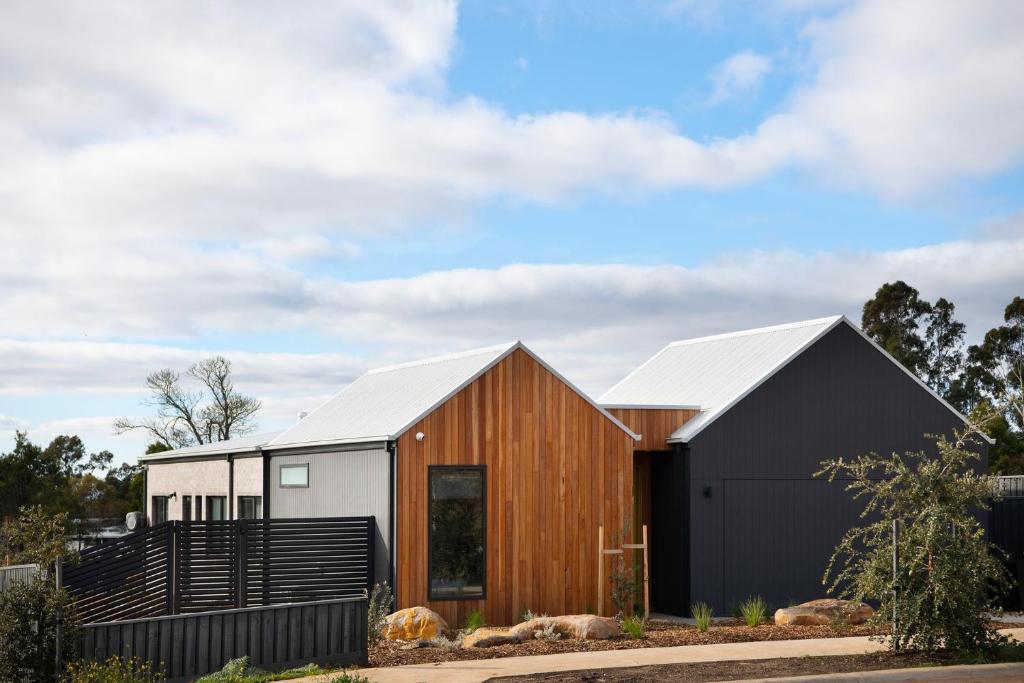 a house with a black and white exterior at Bluestone Haus - stylish home in Daylesford