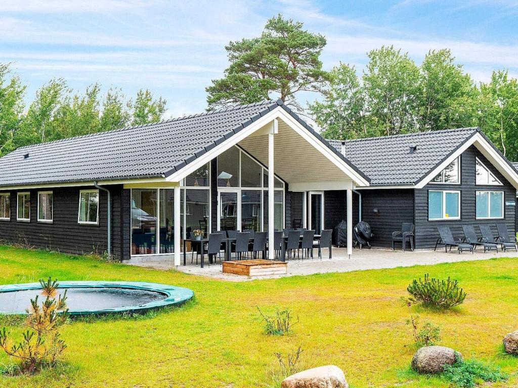 a house with a pool in the yard at 18 person holiday home in Væggerløse in Marielyst