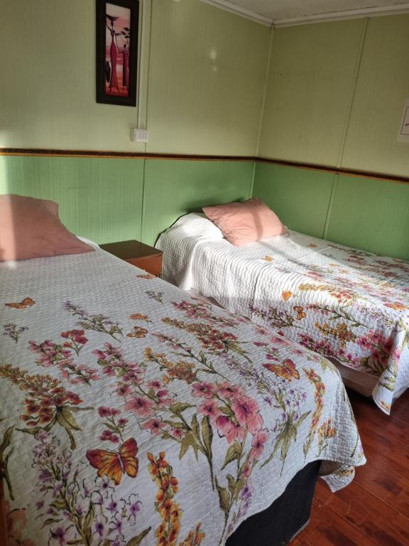 Postel nebo postele na pokoji v ubytování Hostal Patagonico