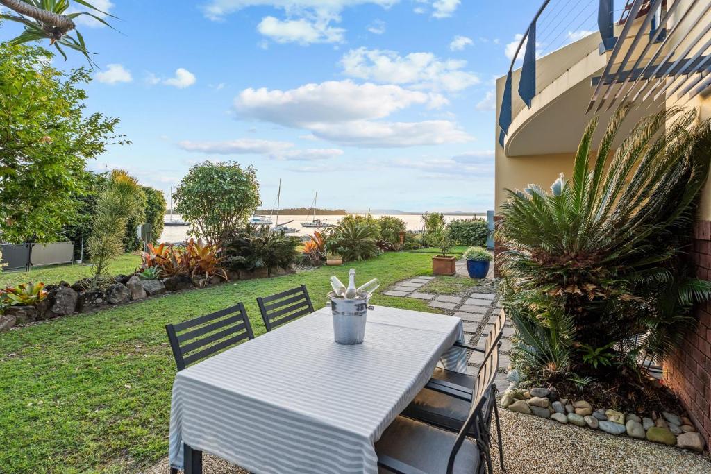 a white table and chairs on a patio at Riverview Apartment 1 Block 1 in Iluka