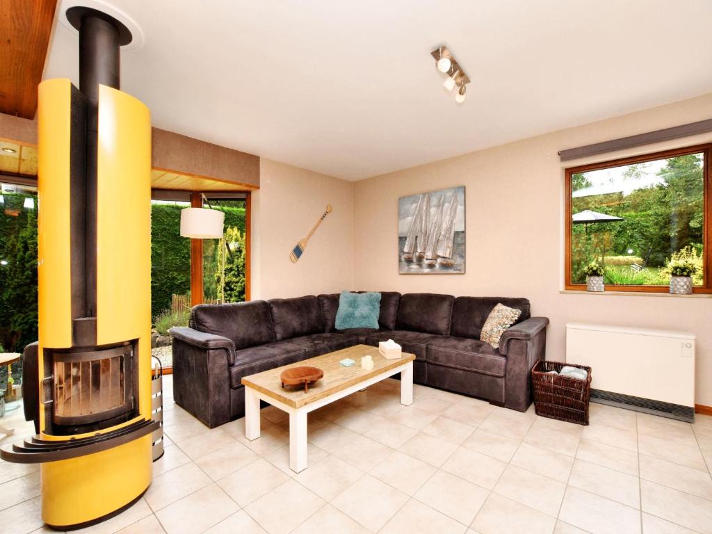 a living room with a couch and a fireplace at Beautiful Holiday Home in Durbuy with Garden in Septon