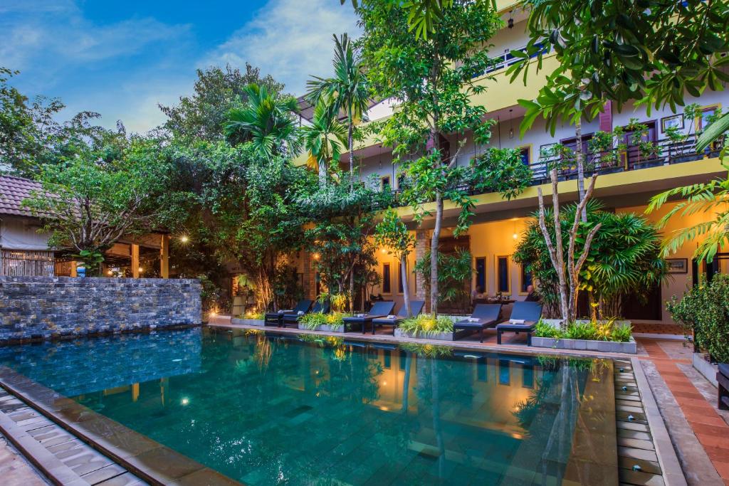 an image of a swimming pool in front of a hotel at Indra Porak Residence Hotel in Siem Reap