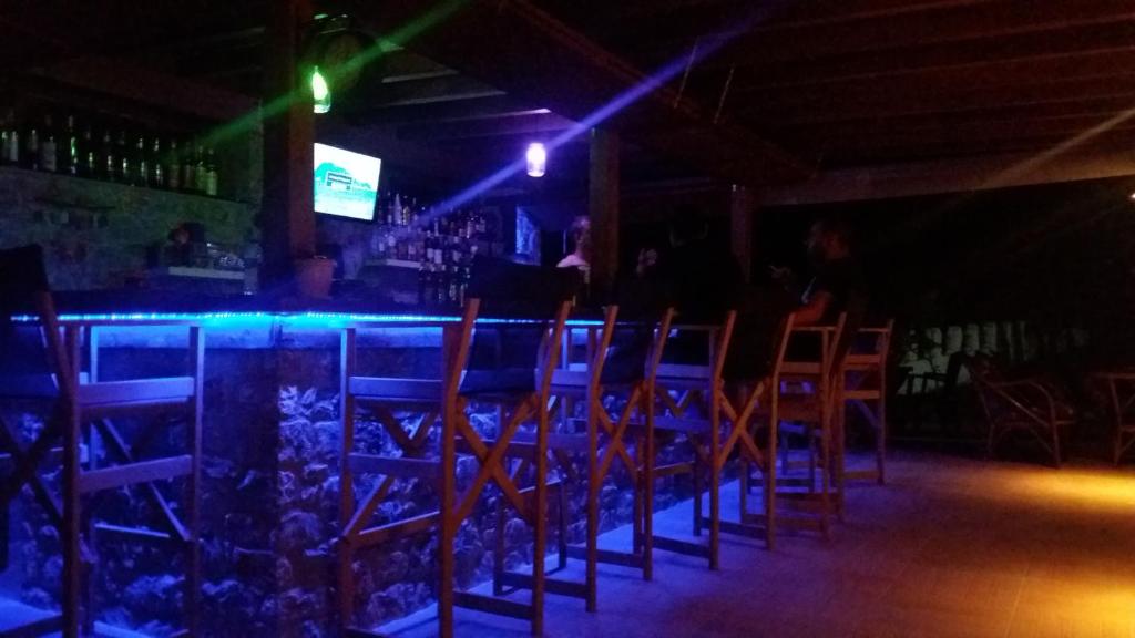 a bar with a bunch of chairs in a room at Hotel Zachos in Troulos