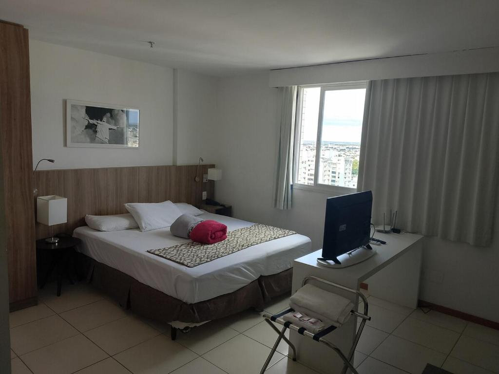 Ένα ή περισσότερα κρεβάτια σε δωμάτιο στο Flat Temporada Centro da Cidade