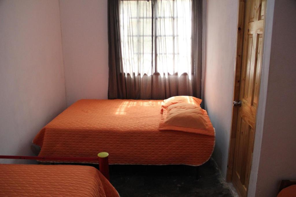 Postel nebo postele na pokoji v ubytování Hostal Mi Castillo