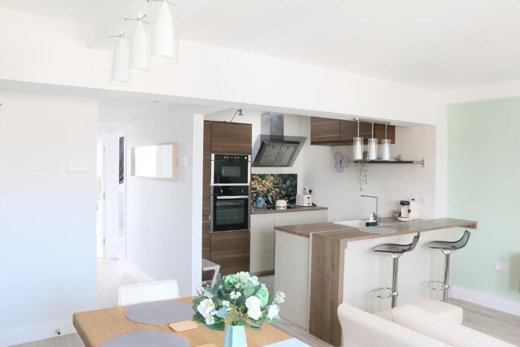 a kitchen and living room with a table and chairs at Stunning Clifton flat in amazing central location in Bristol