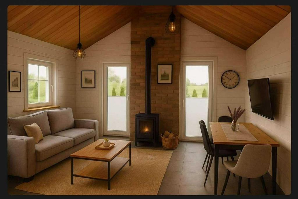 a living room with a couch and a table and a fireplace at Altana Kasztelana - Domek Letniskowy z tarasem i jacuzzi nad Dunajcem Velo in Wojnicz