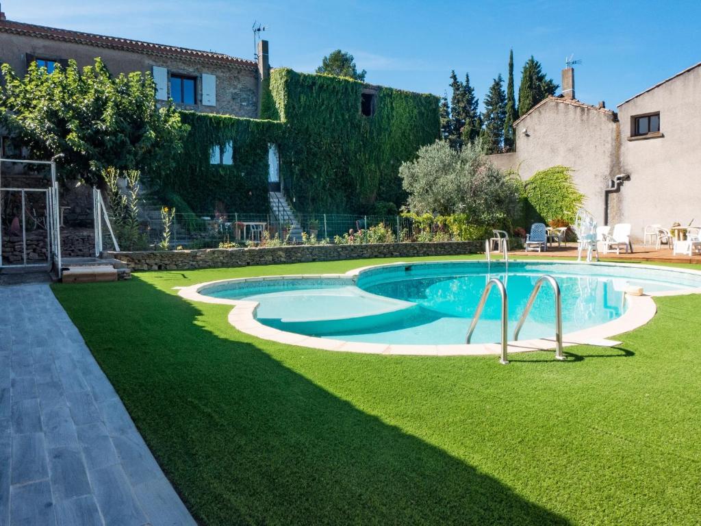 a swimming pool in the yard of a house at Holiday Home in Montbrun with Pool & Vineyards in Montbrun-des-Corbières