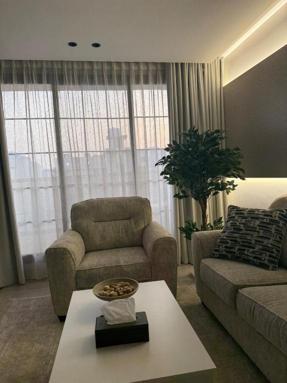 a living room with a couch and a coffee table at Malath - The Bohemian Haven in Dammam