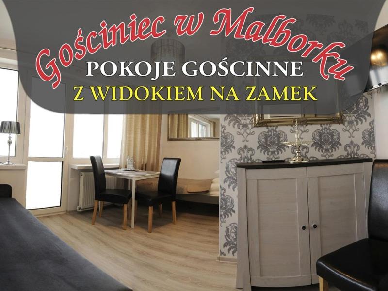 a living room with a table and a dining room at Gościniec w Malborku in Malbork