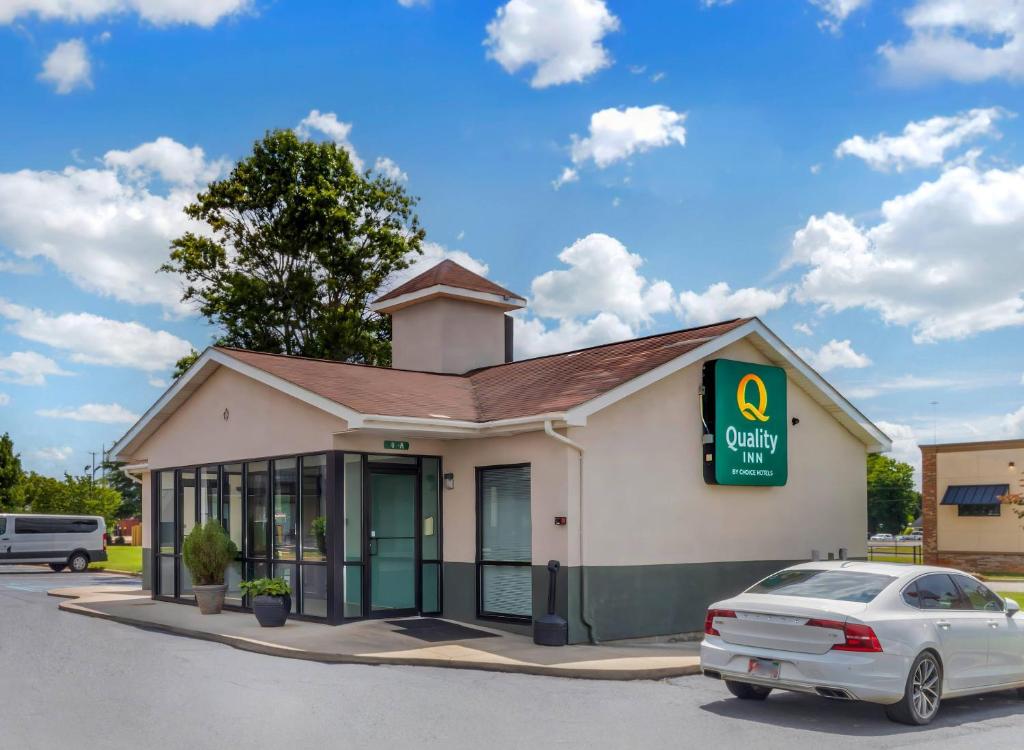 a building with a car parked in front of it at Quality Inn Madison - Huntsville in Madison