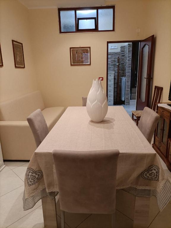 a white vase sitting on a table in a living room at La Fenice in Mola di Bari