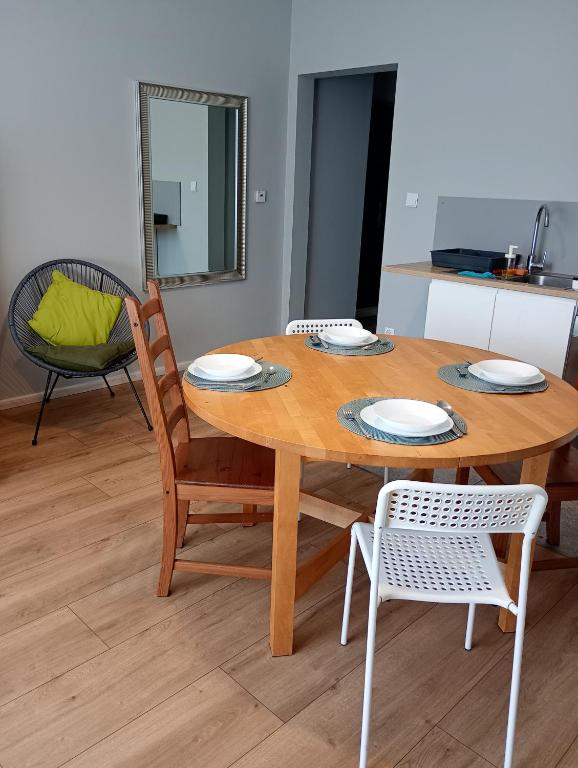a wooden table with two chairs and a dining room at Apartament Rzewuskiego in Przemyśl