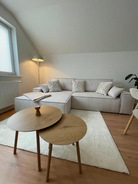 a living room with a white couch and a table at Ferienwohnung-Pappelhof in Dannau