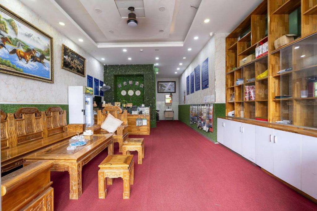 a restaurant with wooden tables and chairs in a room at Tân Quý Đô Hotel in Thu Dau Mot