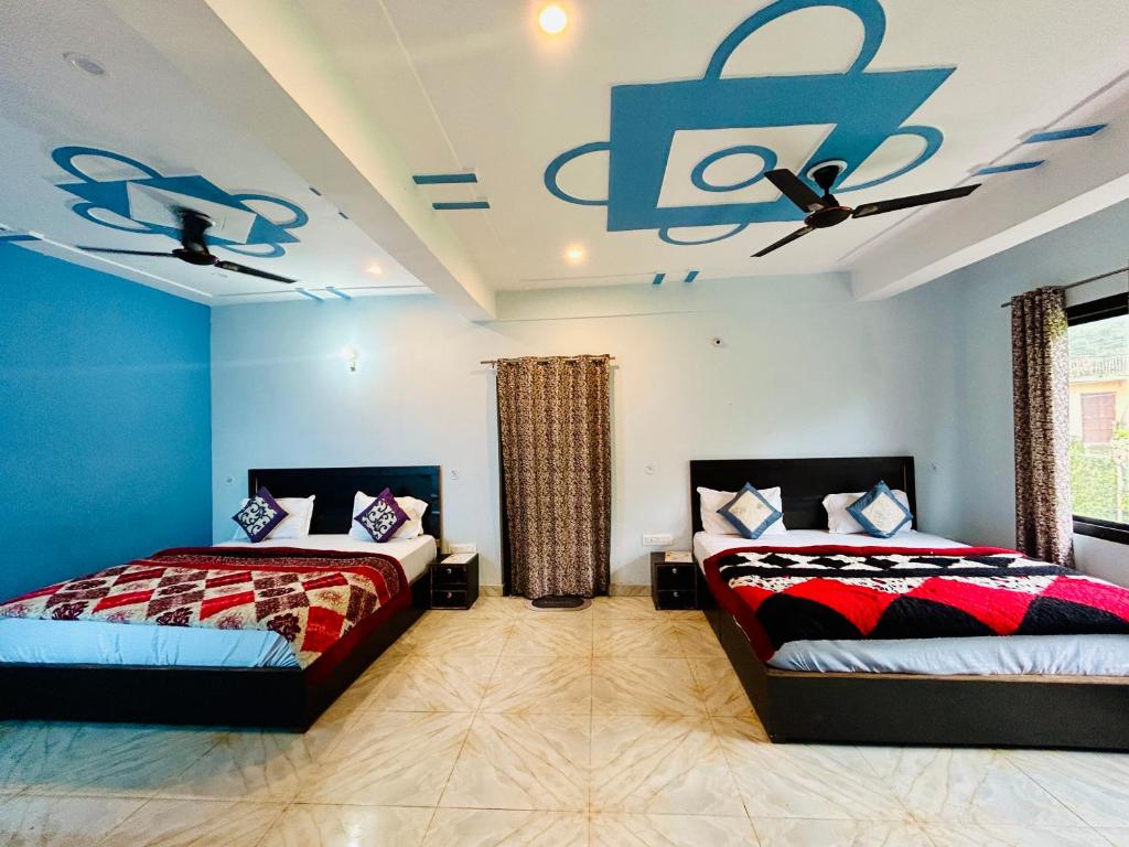 a bedroom with two beds and a ceiling fan at Green Valley Hotel in Lansdowne