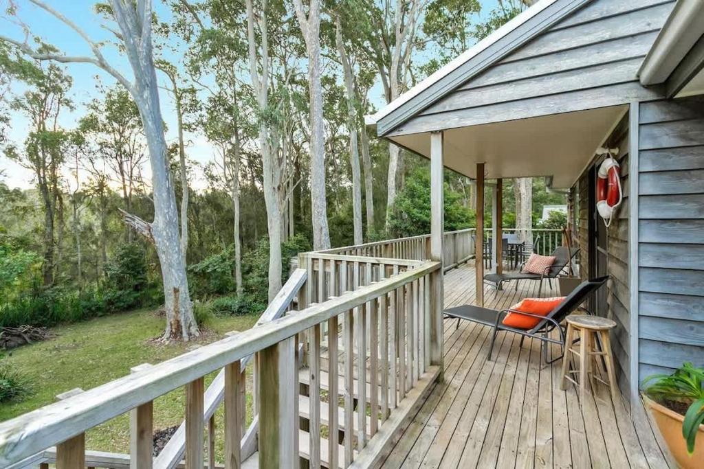 a wooden deck with chairs on a house at Bawley retreat in Bawley Point