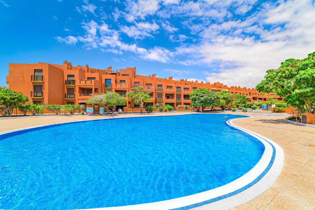 a large swimming pool in front of a building at Sotavento Horizon Views Suite in La Tejita