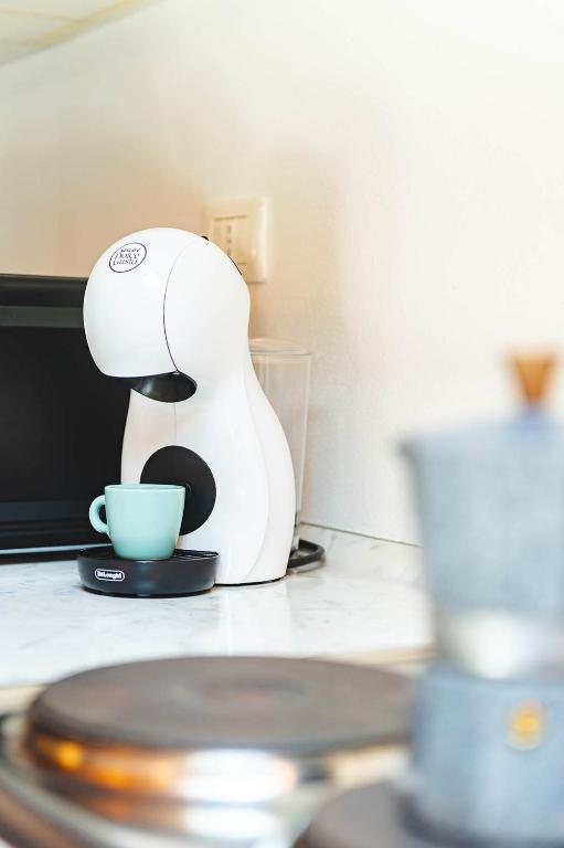 a coffee maker sitting on a counter with a cup at Panoramic refuge 5-Baita Lago Blu in Bellano