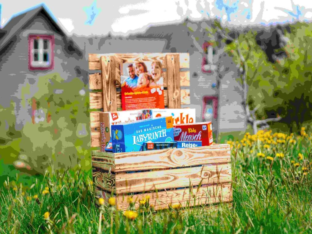 a stack of books in a wooden crate in a field at Holiday homes in the Schierke Harzresort on the Brocken, Schierke in Schierke