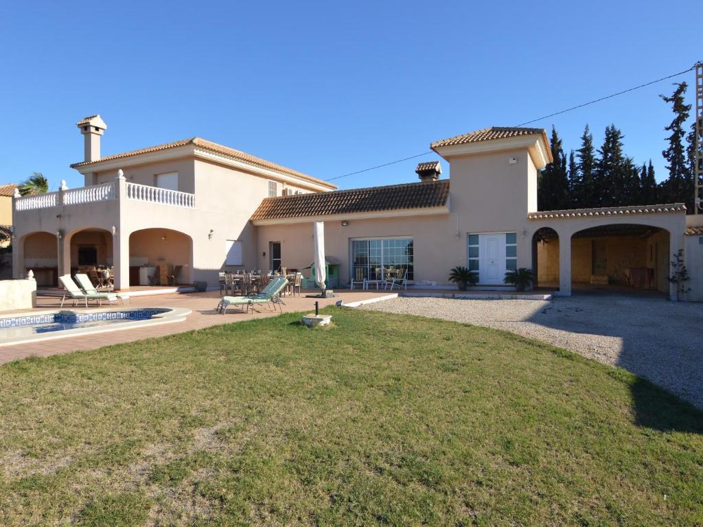 a large house with a lawn in front of it at Villa in El Agar with Private Pool and Beaches in Mina Blanca