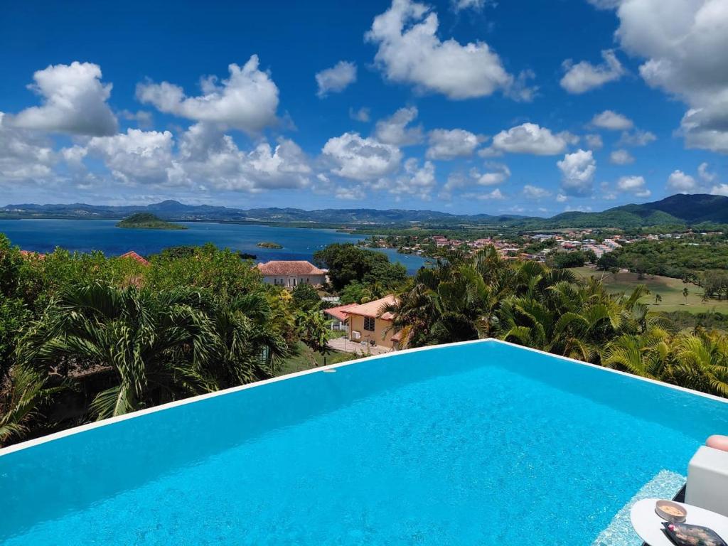 a view of the water from a villa with a swimming pool at Latitude vue unique in Les Trois-Îlets