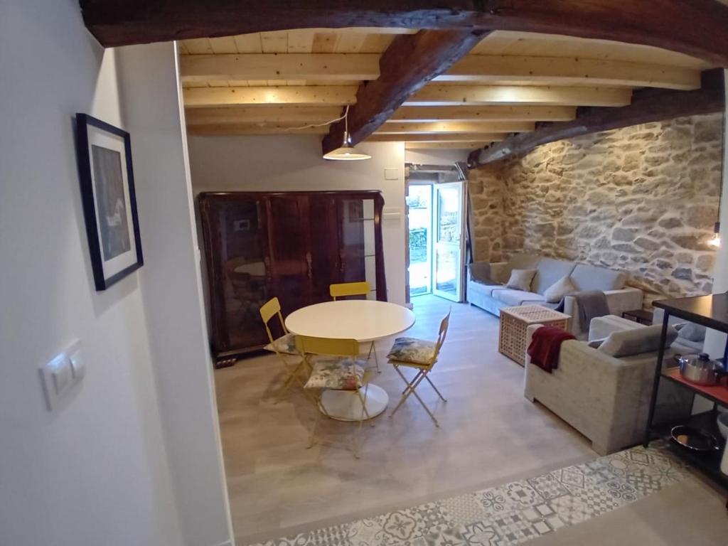 a living room with a table and a couch at Duplex en Ribeira Sacra in Sistín