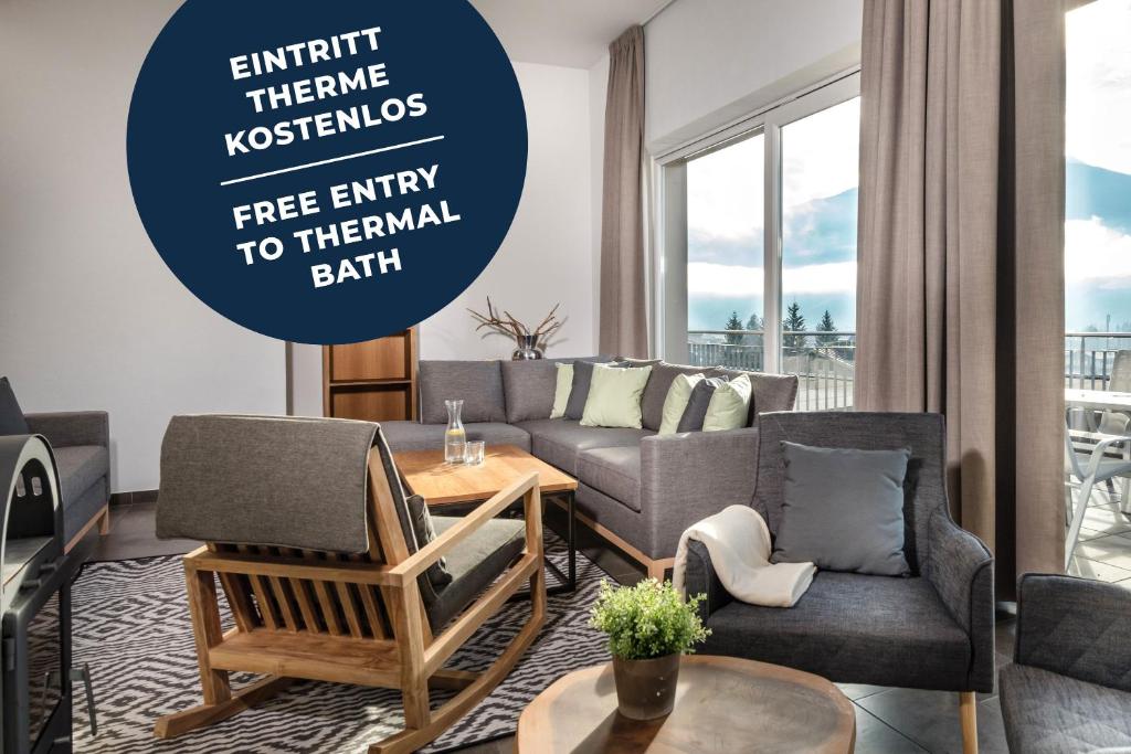 a living room with a couch and a table at AlpenParks Residence Bad Hofgastein - gratis Thermeneintritt in Bad Hofgastein