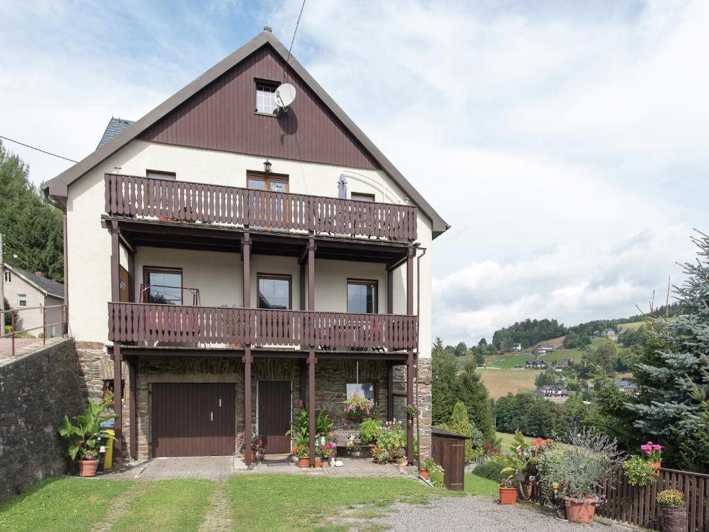 a house with a balcony on the side of it at Cozy Ski Base with Garden in Breitenbrunn