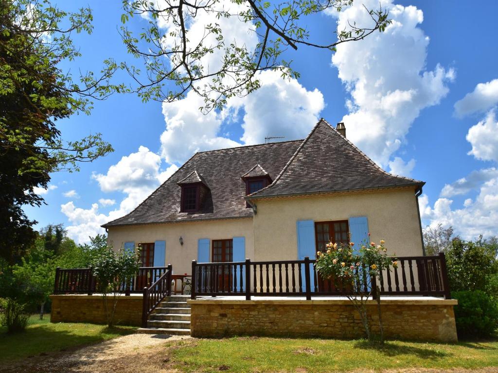 a large white house with a porch and stairs at Labardamier Garden Home in Villefranche-du-Périgord