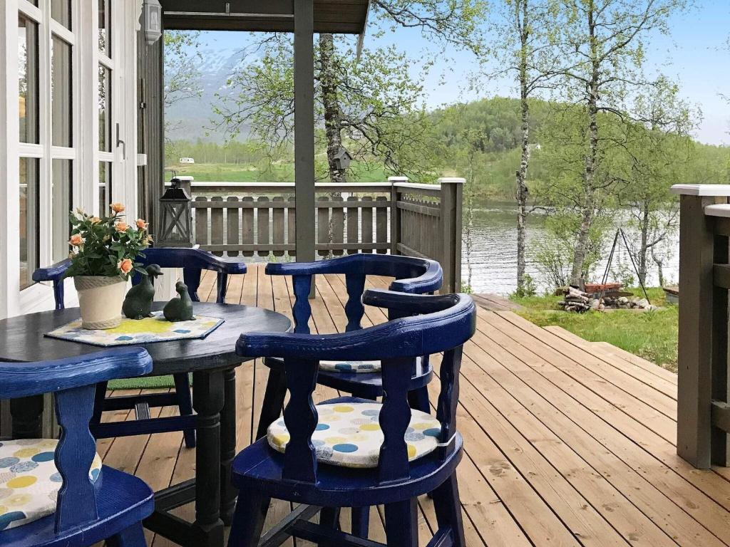 a wooden deck with a table and chairs on a porch at 6 person holiday home in Ballangen in Ballangen