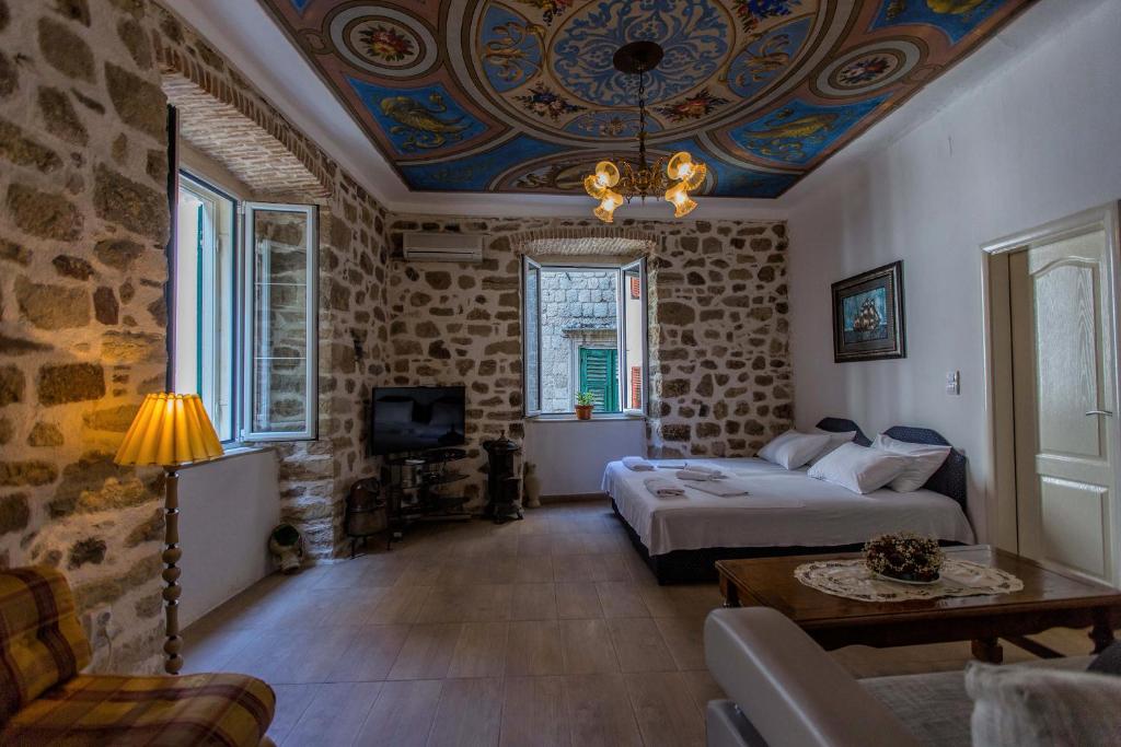 a room with a bed and a couch and a table at Royal House in Kotor