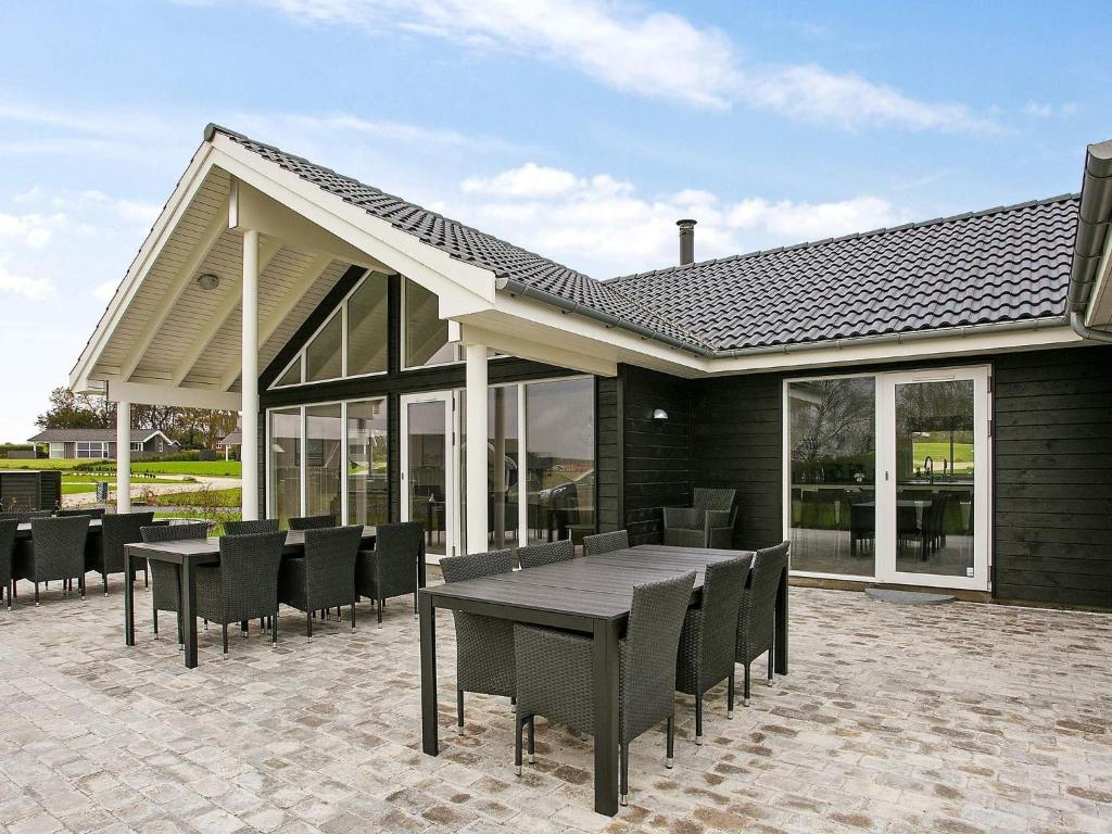 a patio with a wooden table and chairs at 5 star holiday home in Faaborg in Faaborg